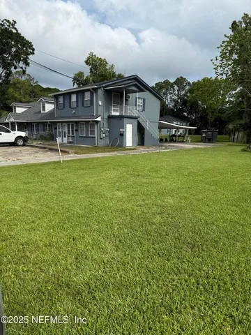a front view of building with yard