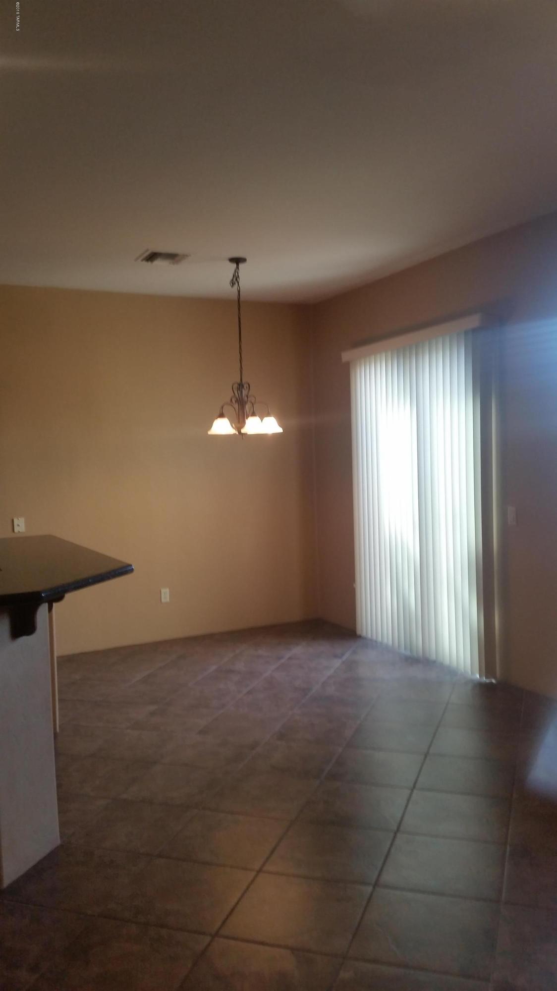 478 East Cedarvale Road Tucson, AZ 85704 - Photo 4 of 39 an empty room with chandelier fan and windows