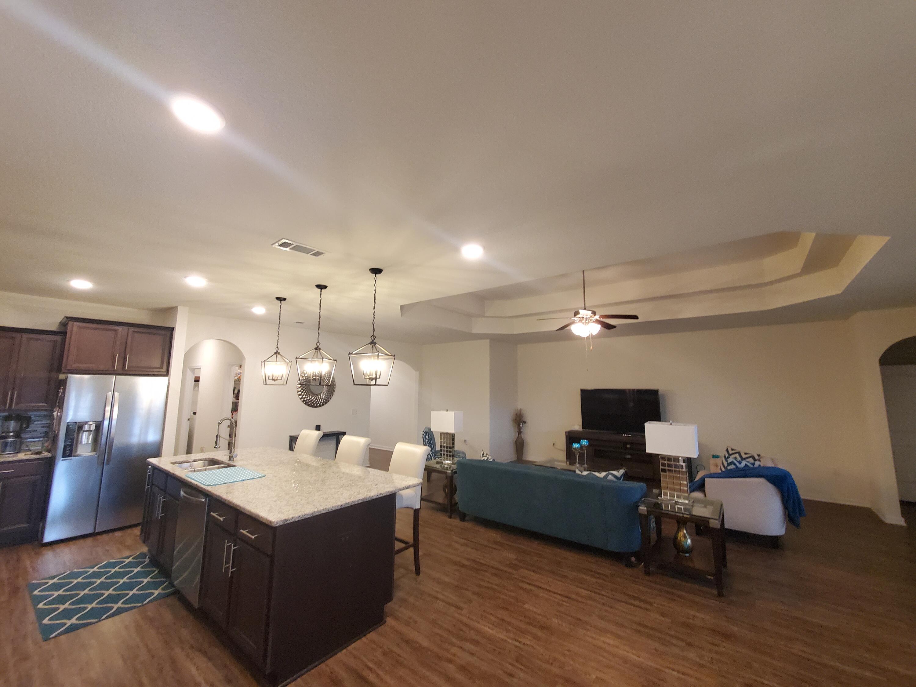 329 Merlin Court Crestview, FL 32539 - Photo 11 of 35 a large living room with stainless steel appliances kitchen island granite countertop a large counter top and couch