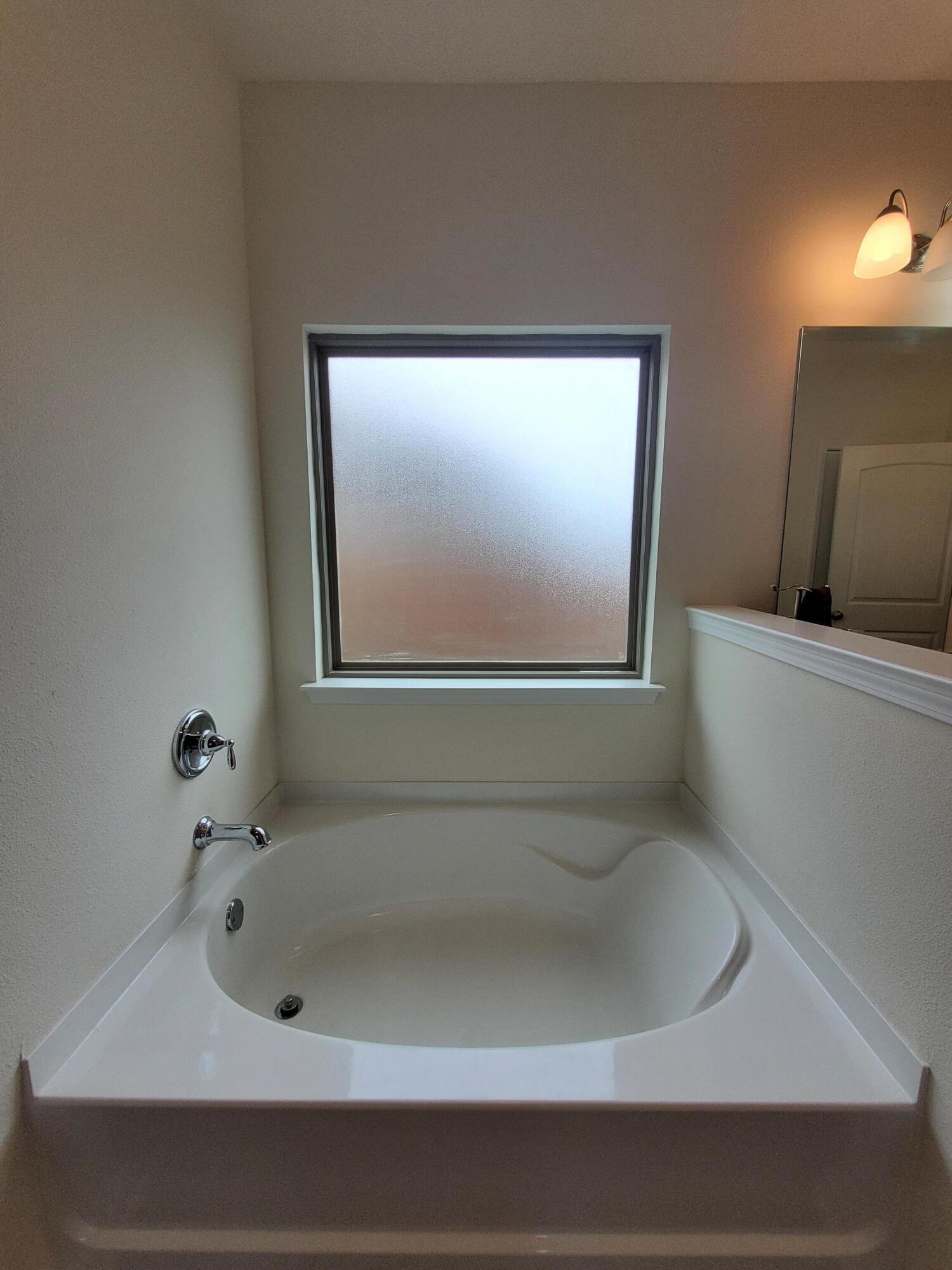 329 Merlin Court Crestview, FL 32539 - Photo 15 of 35 a bathroom with a bathtub and mirror