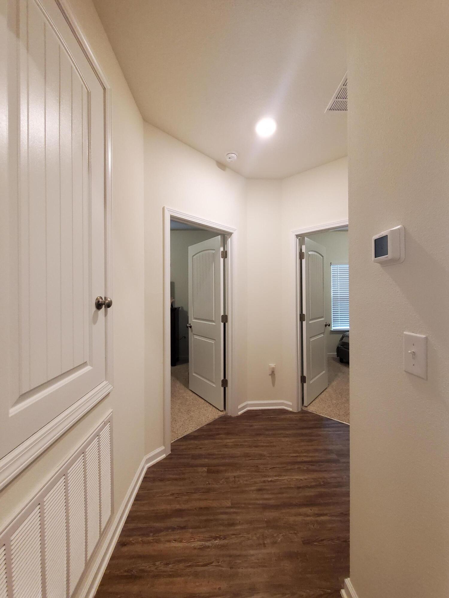 329 Merlin Court Crestview, FL 32539 - Photo 17 of 35 a view of a hallway with wooden floor and closet area