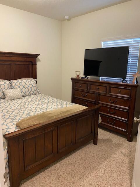 329 Merlin Court Crestview, FL 32539 - Photo 18 of 35 a bedroom with a bed and flat screen tv