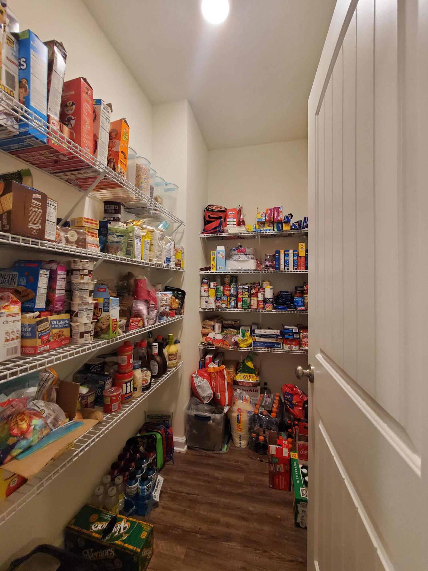 329 Merlin Court Crestview, FL 32539 - Photo 23 of 35 a room with lots of books and a refrigerator