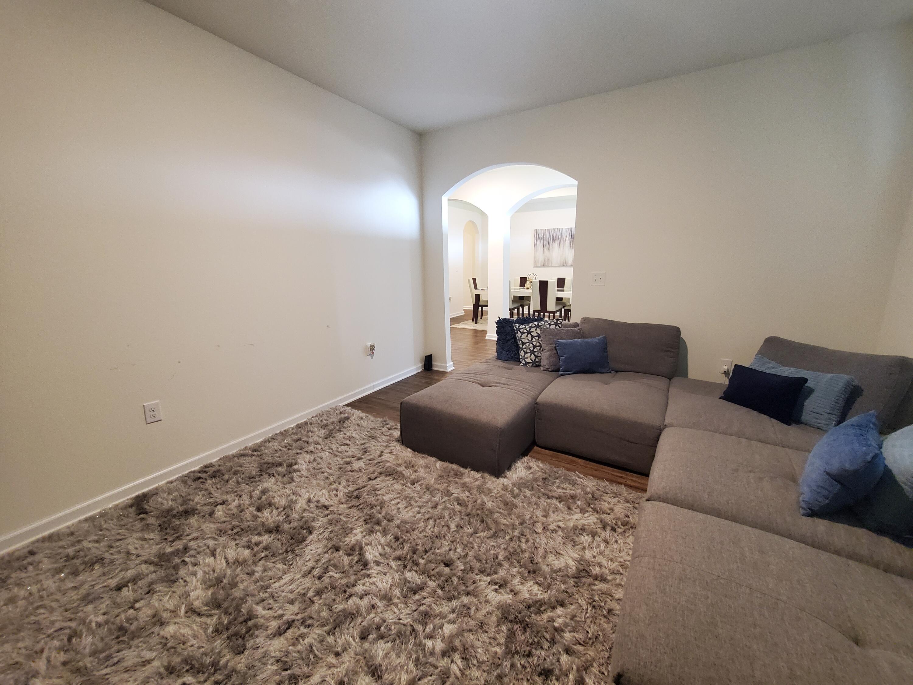 329 Merlin Court Crestview, FL 32539 - Photo 27 of 35 a living room with a couch and a mirror