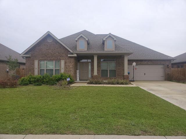 329 Merlin Court Crestview, FL 32539 - Photo 3 of 35 a front view of a house with garden