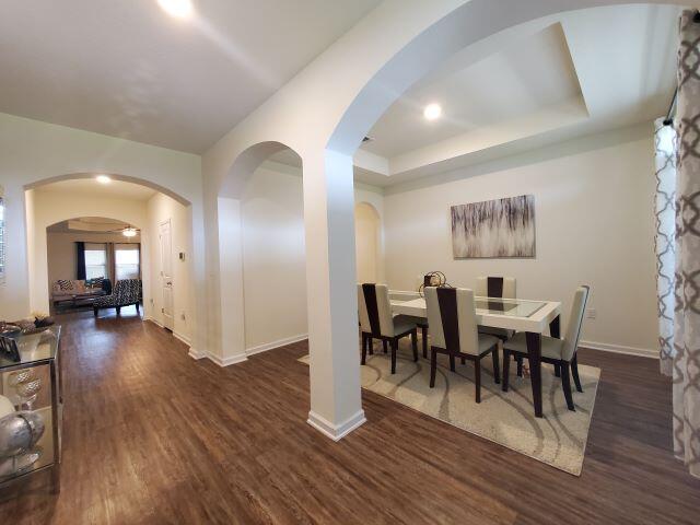 329 Merlin Court Crestview, FL 32539 - Photo 4 of 35 a view of a dining room with furniture and wooden floor