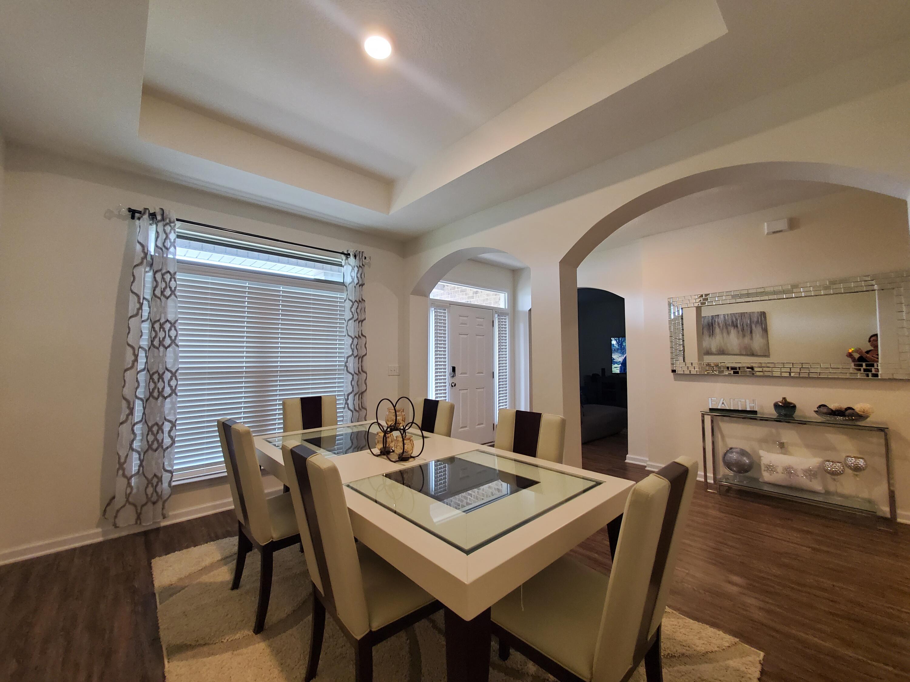329 Merlin Court Crestview, FL 32539 - Photo 7 of 35 a view of a dining room with furniture and wooden floor