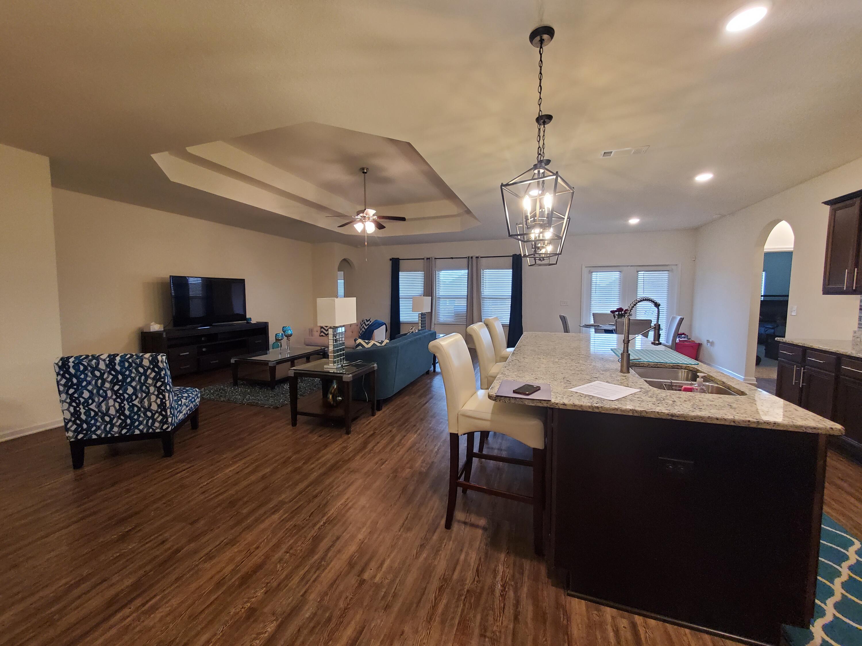 329 Merlin Court Crestview, FL 32539 - Photo 9 of 35 a living room with furniture a window and a chandelier