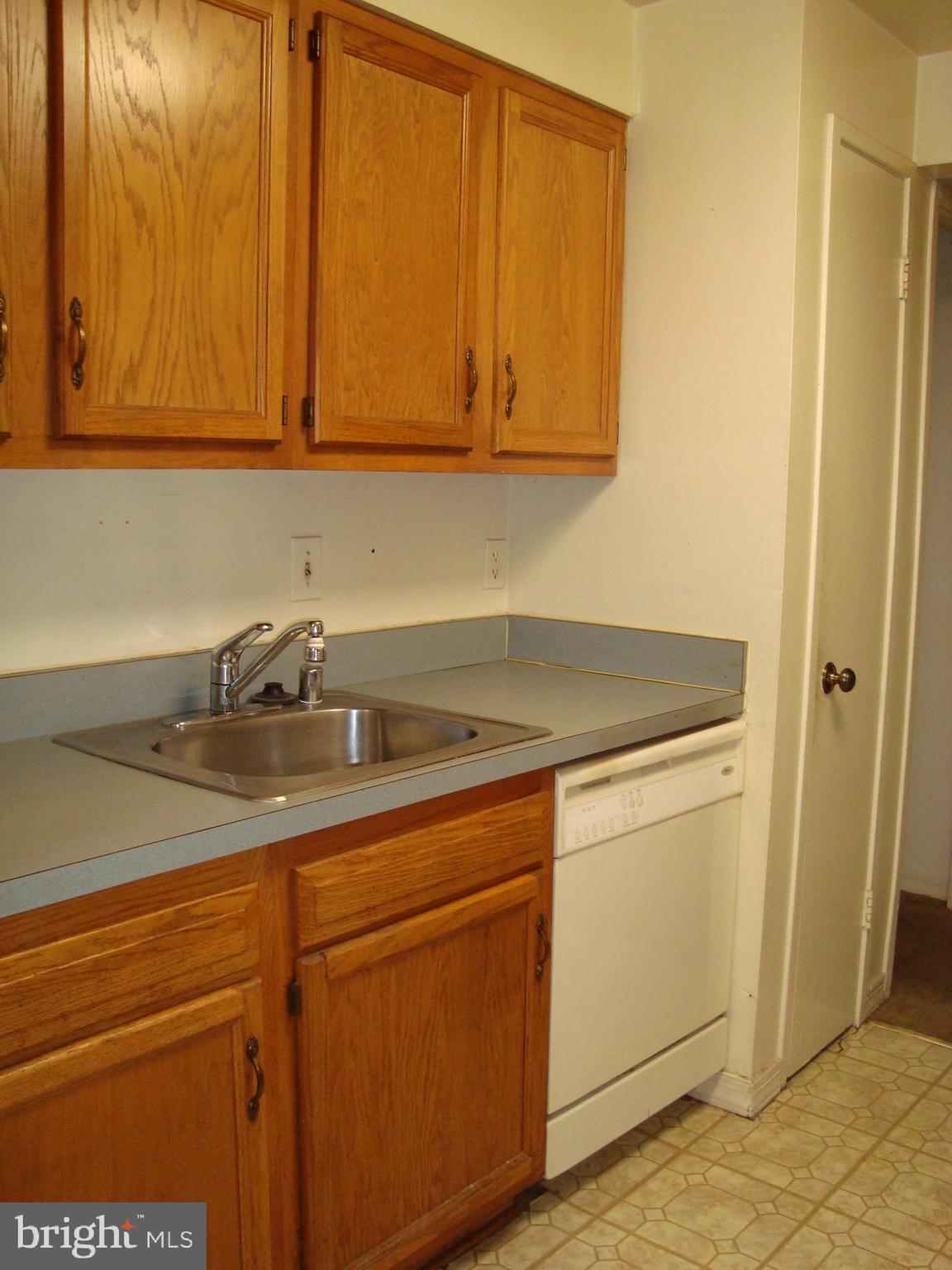 130 Duvall Lane, Unit 187T3 Gaithersburg, MD 20877 - Photo 12 of 19 a view of a sink and dishwasher with wooden cabinets
