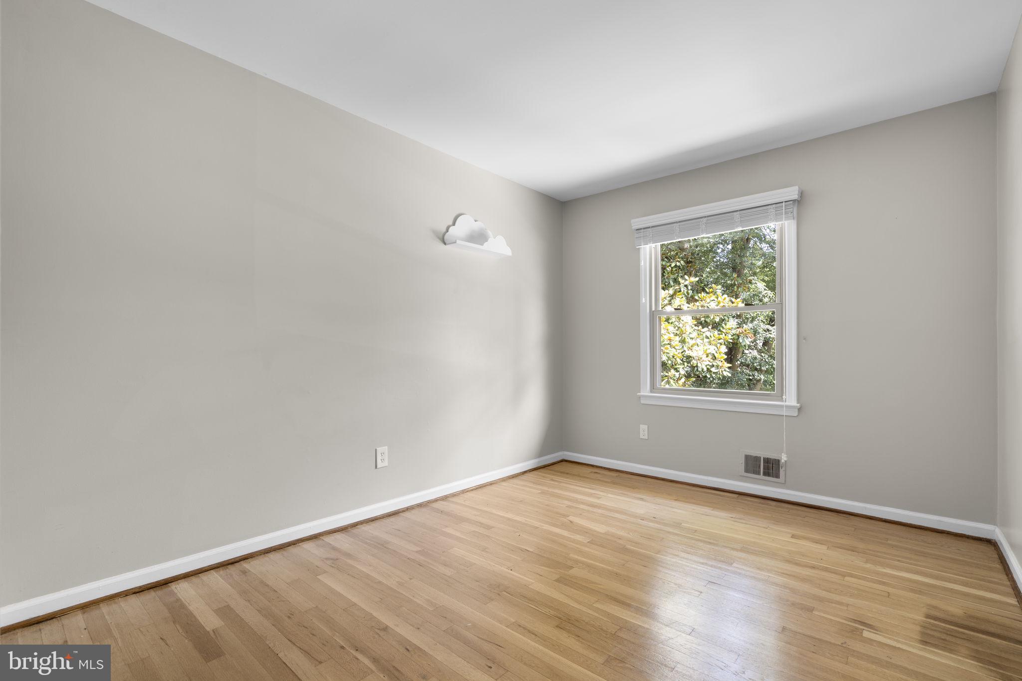 822 Loxford Terrace Silver Spring, MD 20901 - Photo 25 of 61 an empty room with wooden floor and windows