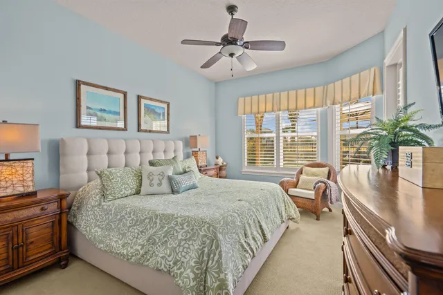 a bedroom with a bed and painting on the wall