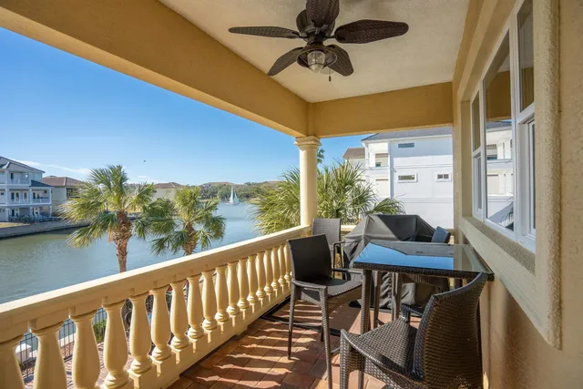 a living room with patio furniture and a floor to ceiling window