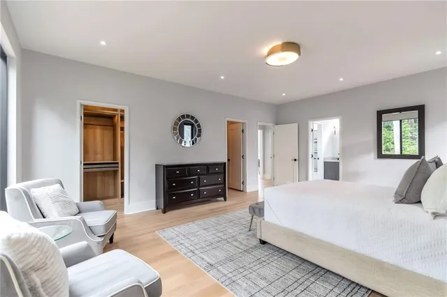 a bathroom with a granite countertop sink a toilet and shower