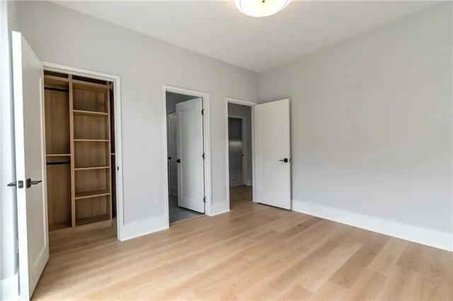 a bathroom with a granite countertop sink toilet and a mirror