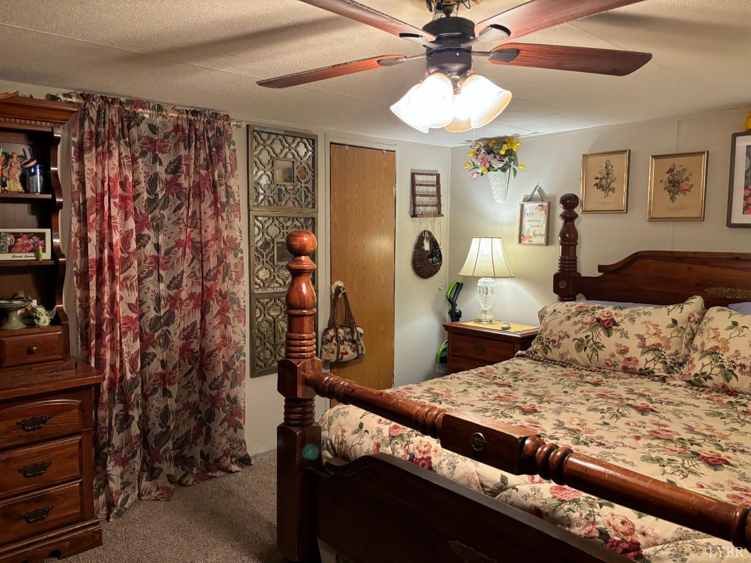 168 Victoria Drive Amherst, VA 24521 - Photo 8 of 9 a bedroom with a bed and a chandelier