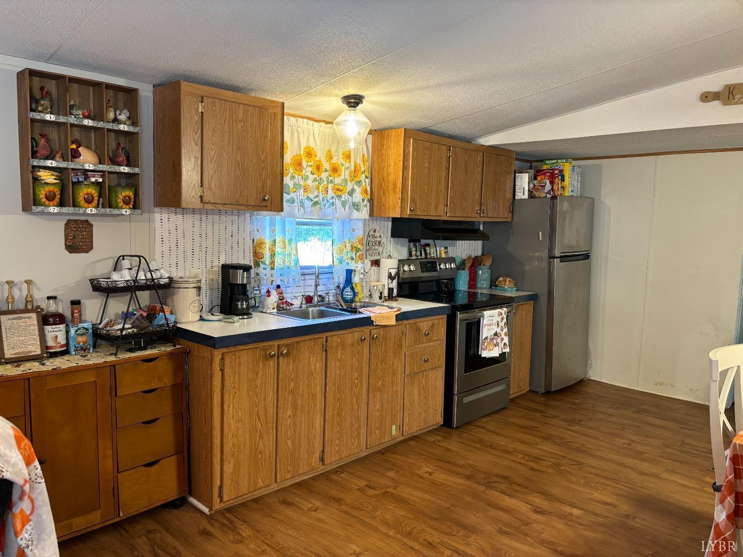 168 Victoria Drive Amherst, VA 24521 - Photo 9 of 9 a kitchen with stainless steel appliances granite countertop a refrigerator a sink dishwasher and wooden cabinets with wooden floor