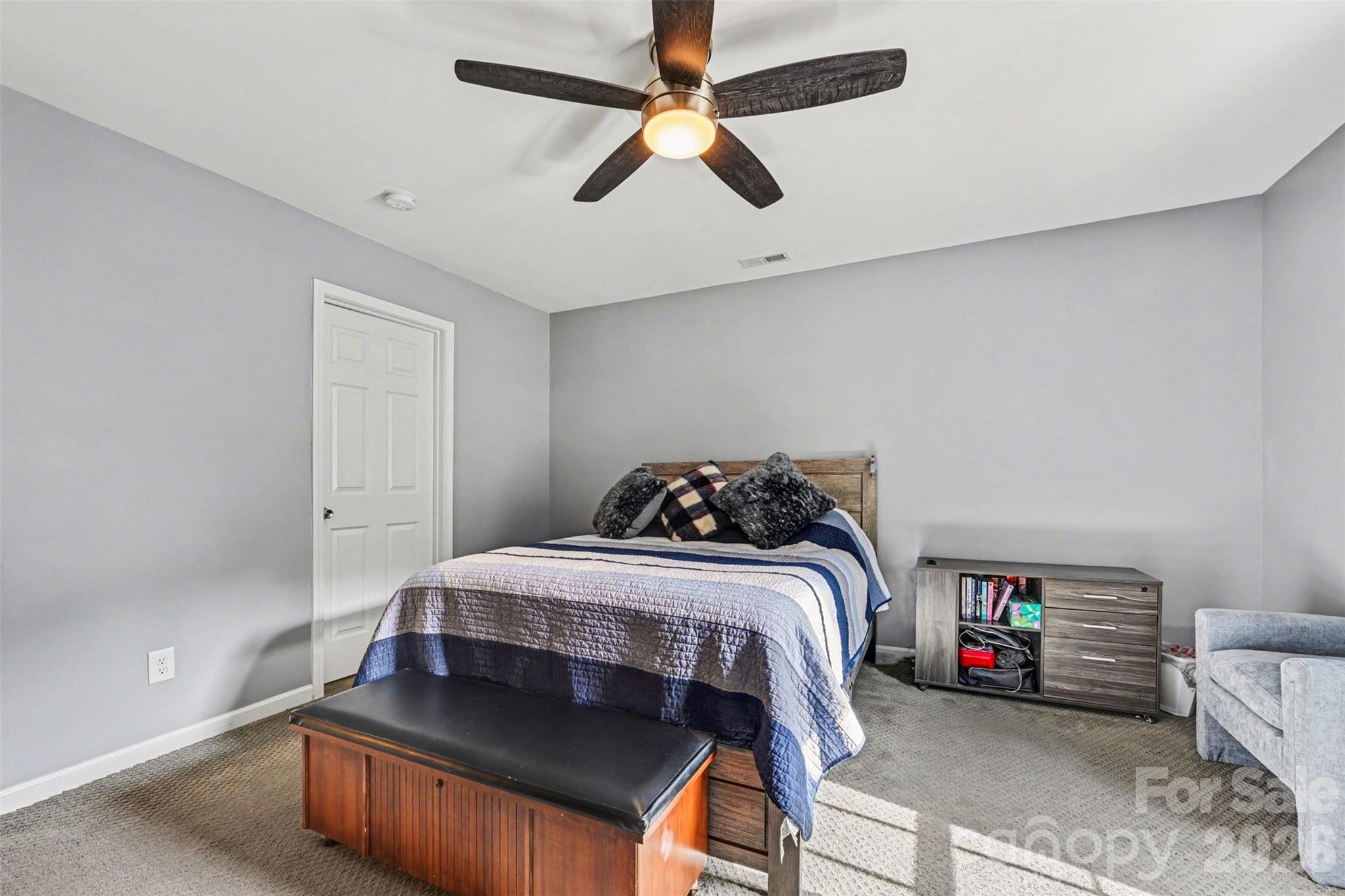 391 Lone Tree Lane Clover, SC 29710 - Photo 12 of 27 a bedroom with a bed and a chandelier