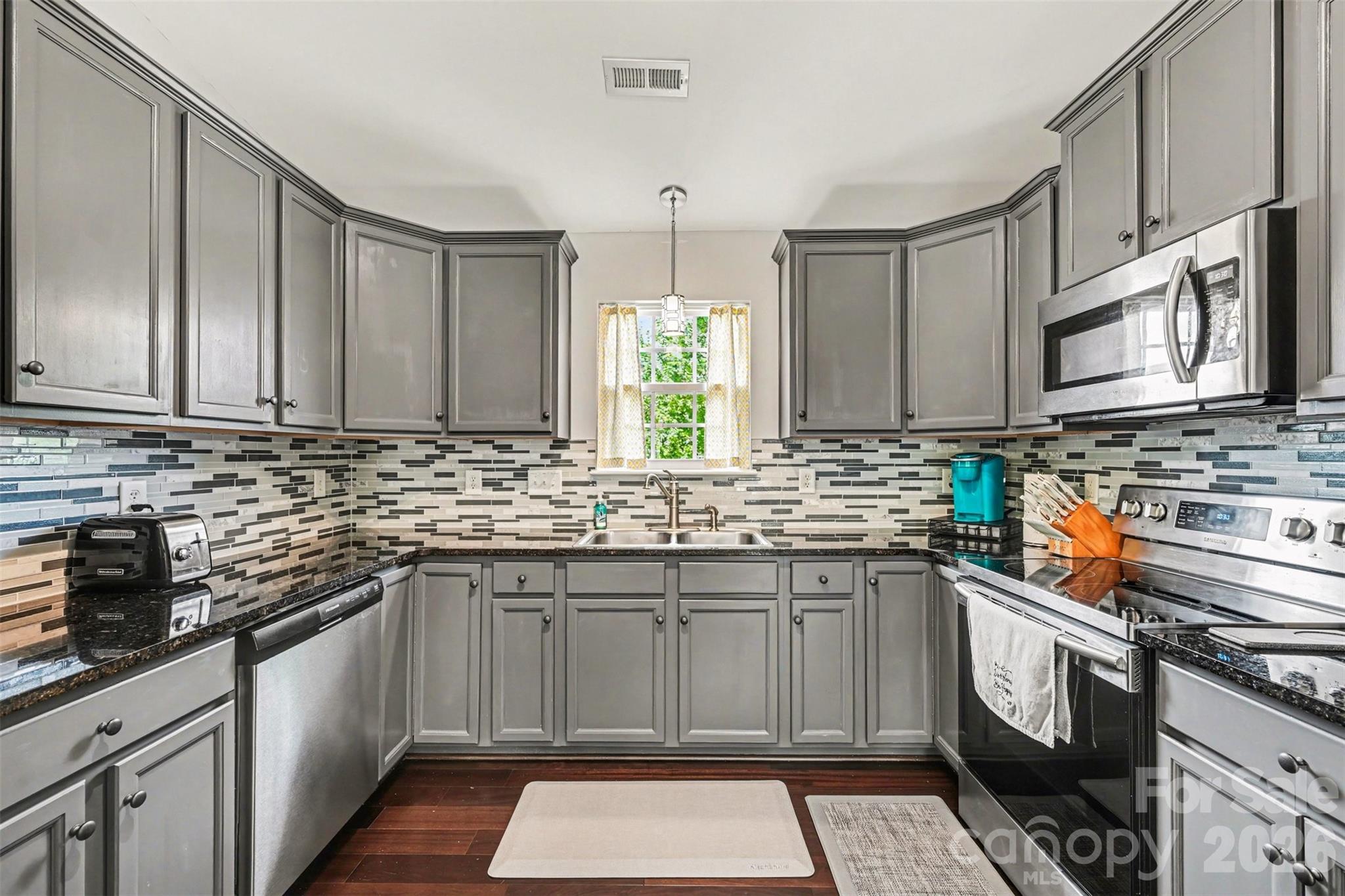 391 Lone Tree Lane Clover, SC 29710 - Photo 9 of 27 a kitchen with stainless steel appliances granite countertop a sink stove and cabinets