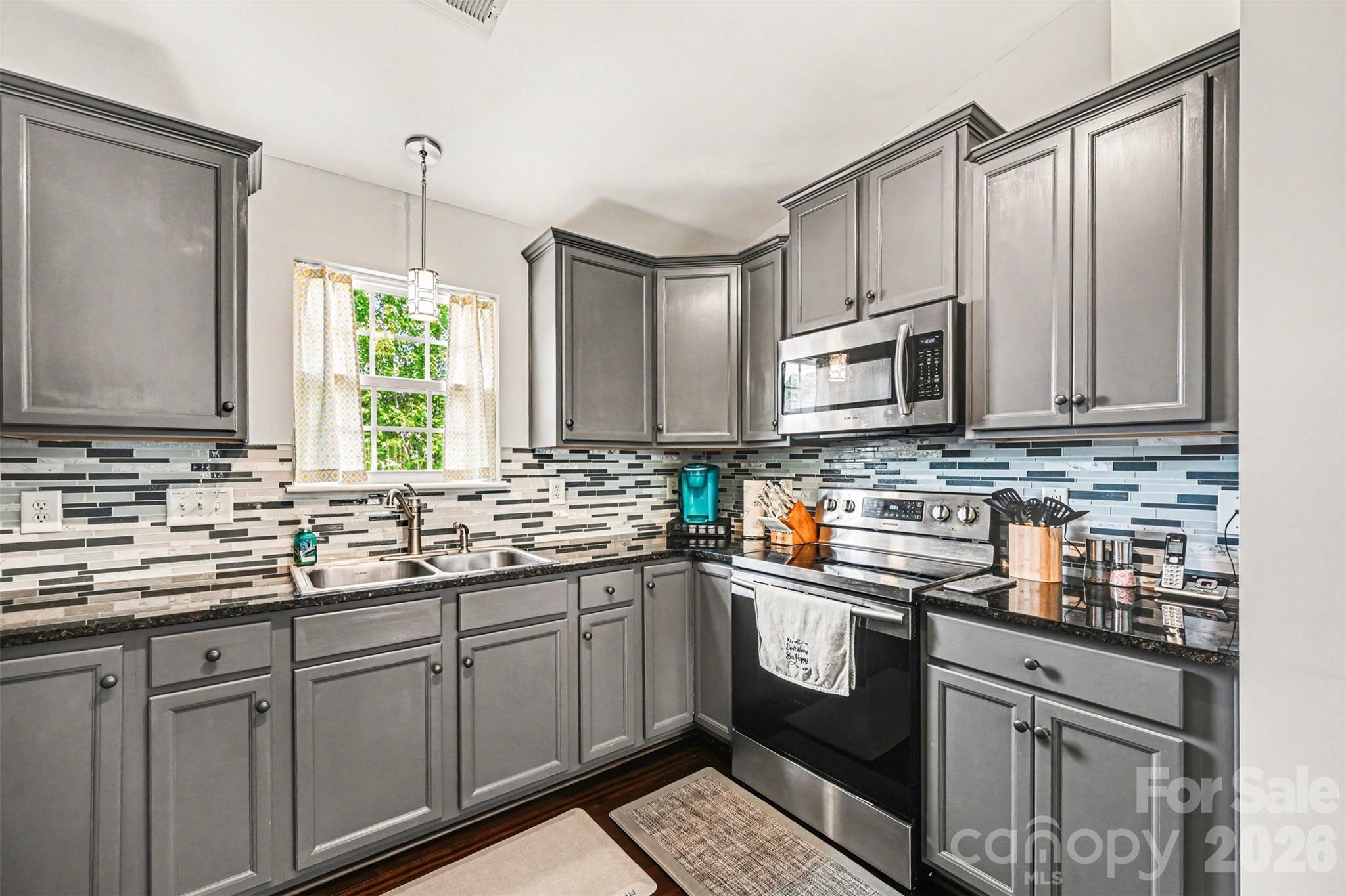 391 Lone Tree Lane Clover, SC 29710 - Photo 10 of 27 a kitchen with stainless steel appliances granite countertop a sink stove and microwave