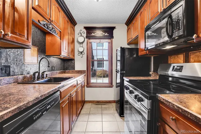 a kitchen with stainless steel appliances granite countertop a stove and a sink