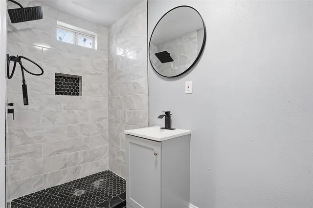 a bathroom with a sink a toilet and a mirror