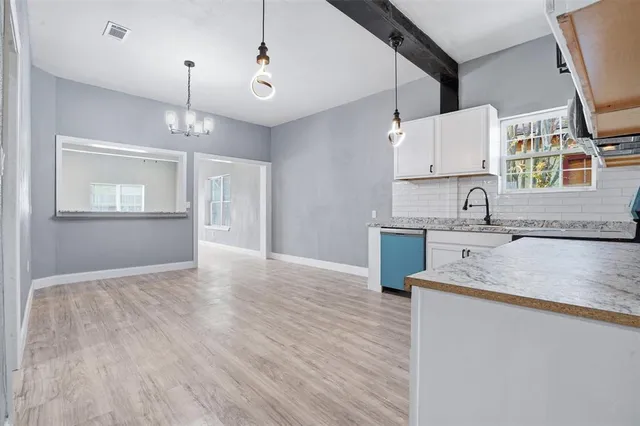 a kitchen with kitchen island a sink stainless steel appliances and cabinets