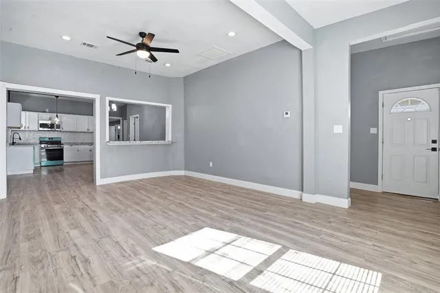 a view of livingroom with hardwood floor and a ceiling fan