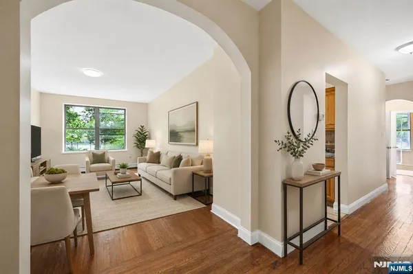 a living room with furniture windows and wooden floor