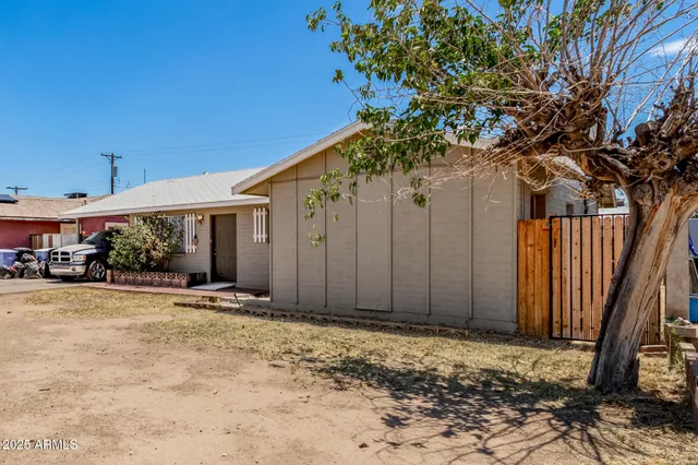 a view of a house with a tree in the background