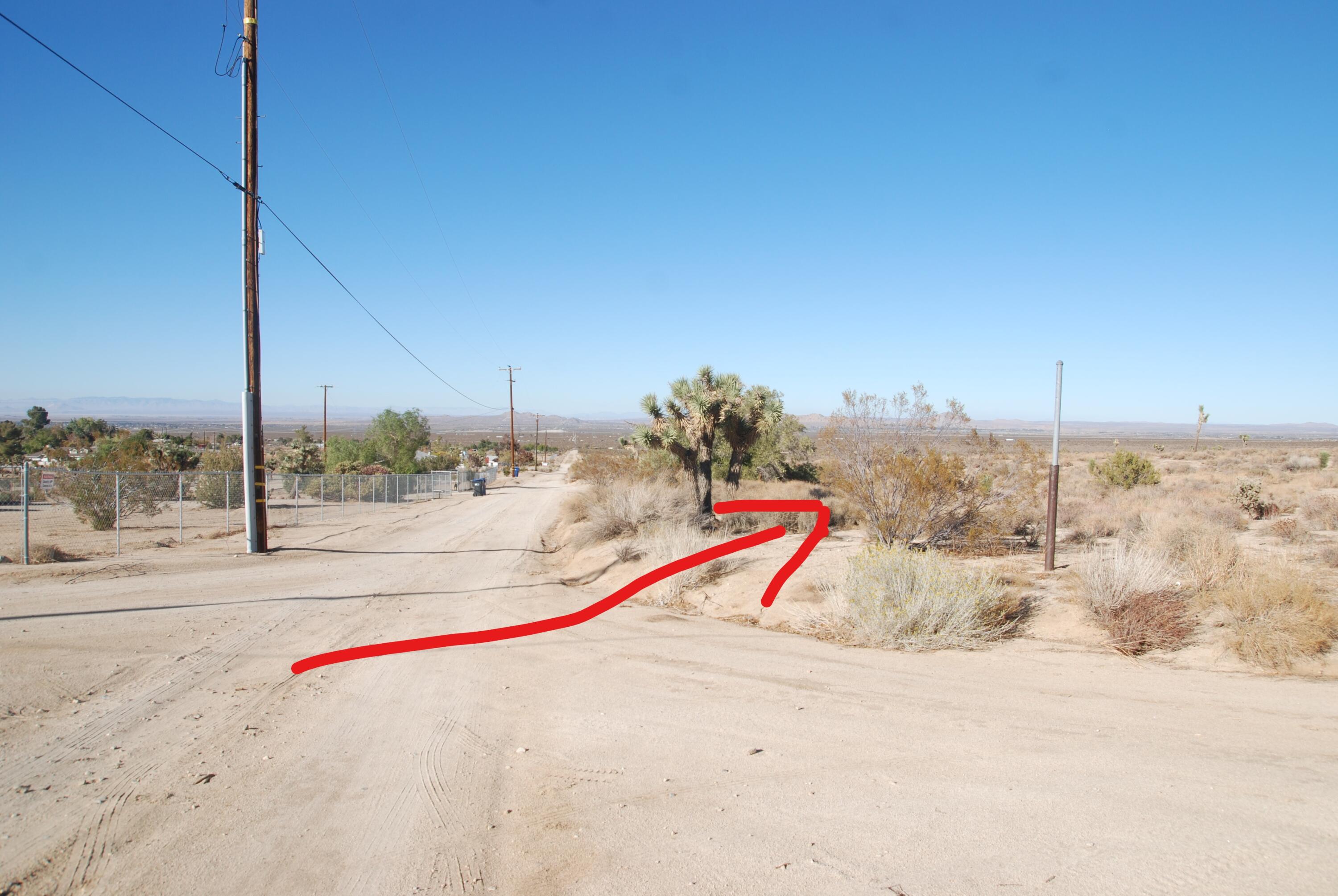 136 Vic Street, Unit E W12 Pearblossom, CA 93553 - Photo 20 of 20 a view of a road with beach and roof