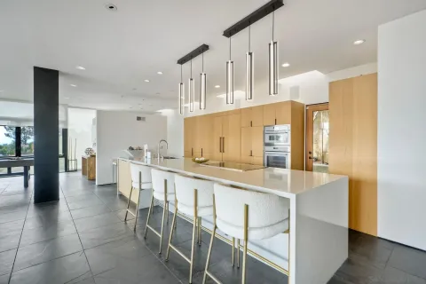 a kitchen with stainless steel appliances kitchen island granite countertop a sink and cabinets