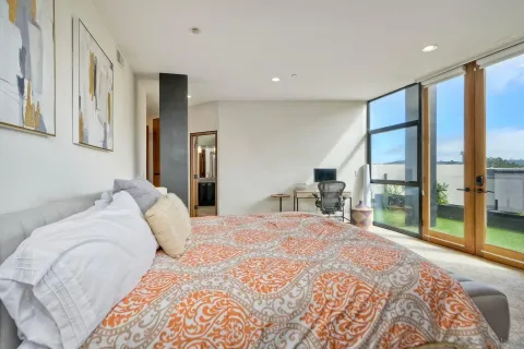 a bedroom with a large bed and a large window