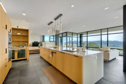 a large kitchen with a large window and stainless steel appliances