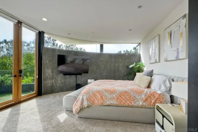 a bedroom with a large bed and a large window