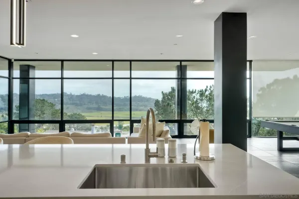 a view of kitchen with a large window and living room