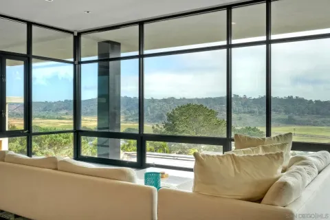 a living room with couches and city view
