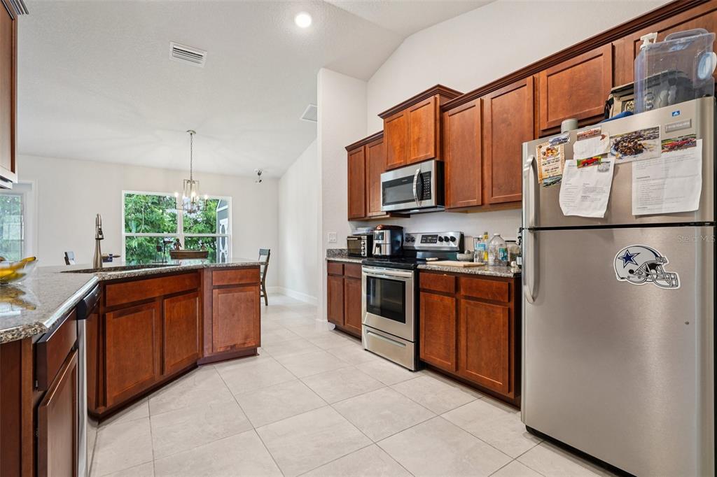67 Northwest 45th Loop Ocala, FL 34475 - Photo 12 of 27 a kitchen with stainless steel appliances granite countertop a refrigerator a stove a sink and dishwasher