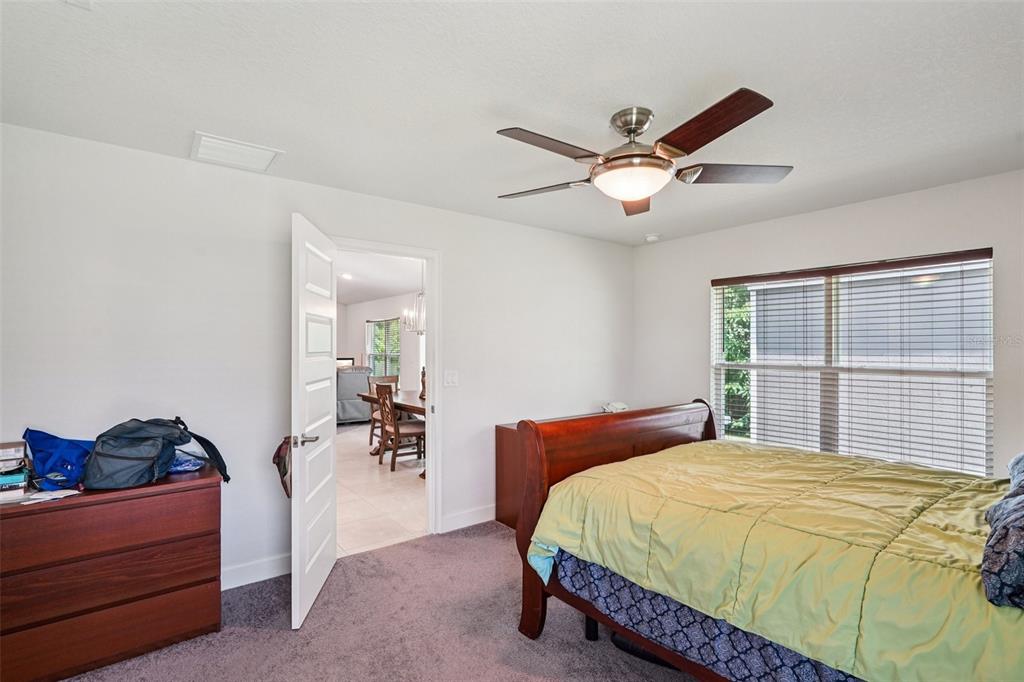 67 Northwest 45th Loop Ocala, FL 34475 - Photo 16 of 27 a bedroom with a bed and a chandelier