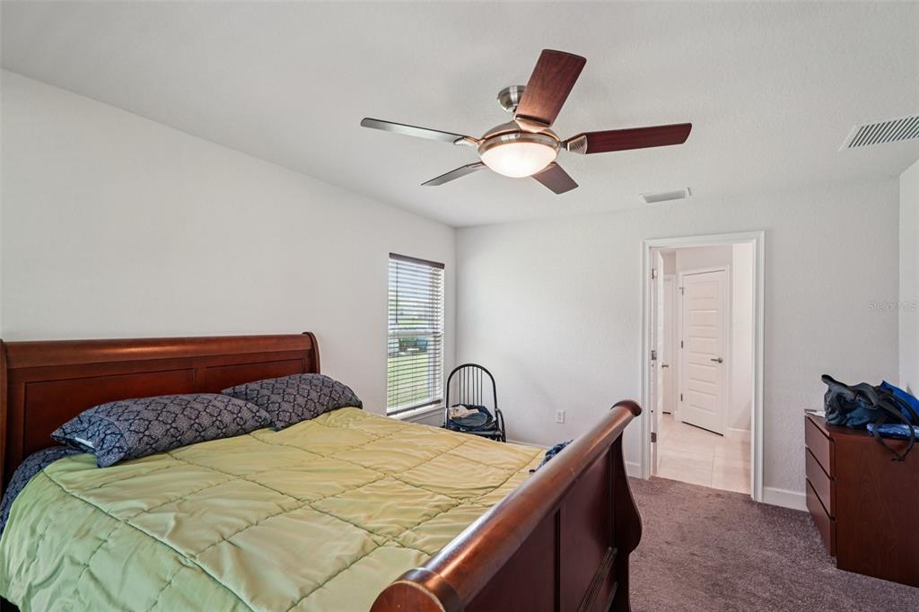 67 Northwest 45th Loop Ocala, FL 34475 - Photo 17 of 27 a bedroom with a bed and a dresser