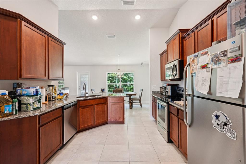 67 Northwest 45th Loop Ocala, FL 34475 - Photo 2 of 27 a kitchen with lots of counter top space a sink and appliances