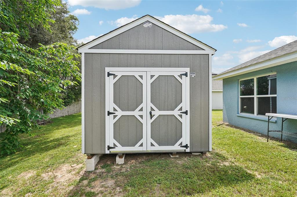 67 Northwest 45th Loop Ocala, FL 34475 - Photo 25 of 27 a front view of a house with garden