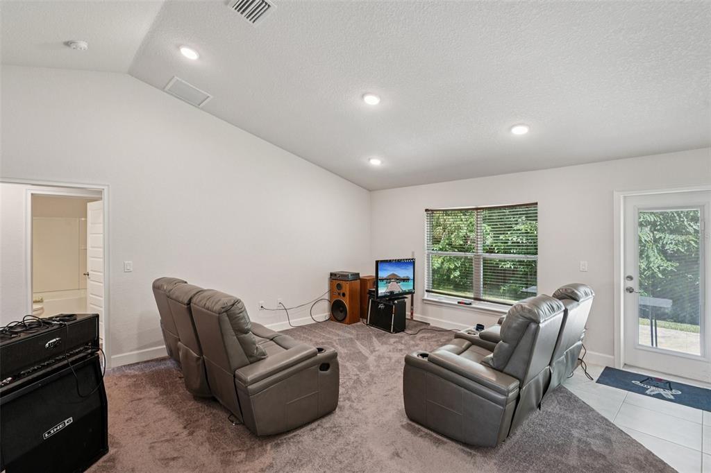 67 Northwest 45th Loop Ocala, FL 34475 - Photo 4 of 27 a living room with furniture and a floor to ceiling window