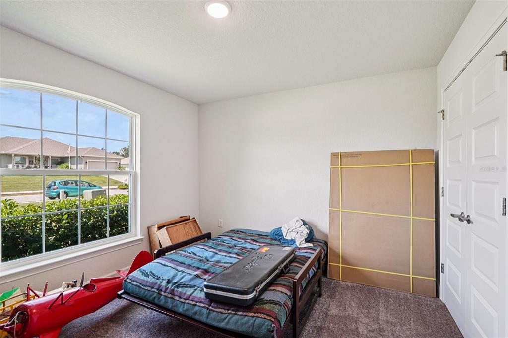 67 Northwest 45th Loop Ocala, FL 34475 - Photo 7 of 27 a bed sitting in a room next to a window