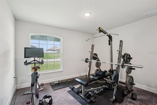 a room with gym equipment and windows