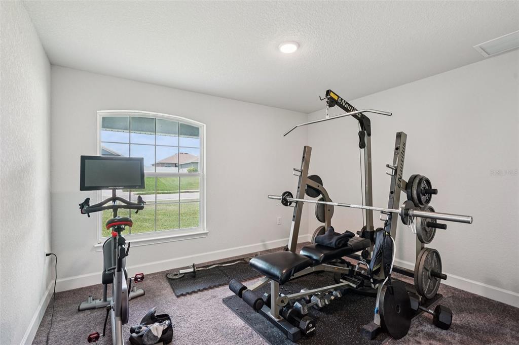 67 Northwest 45th Loop Ocala, FL 34475 - Photo 9 of 27 a room with gym equipment and windows