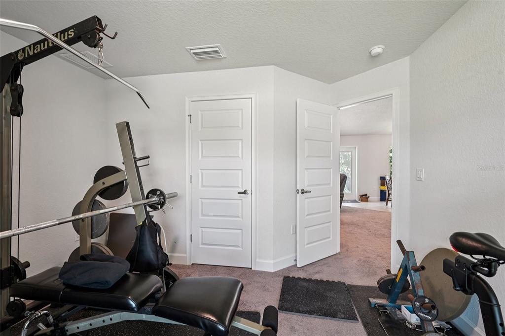 67 Northwest 45th Loop Ocala, FL 34475 - Photo 10 of 27 a room with gym equipment
