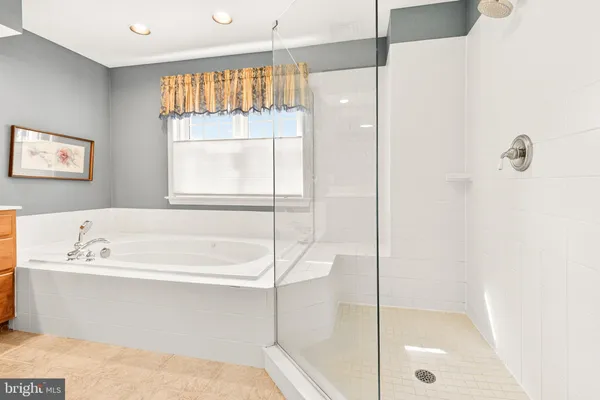 a bedroom with two beds and a flat screen tv