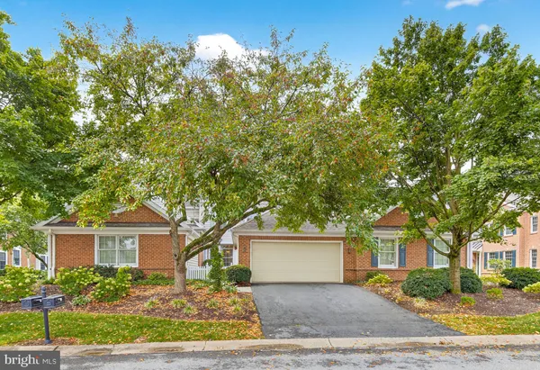front view of a house with a tree