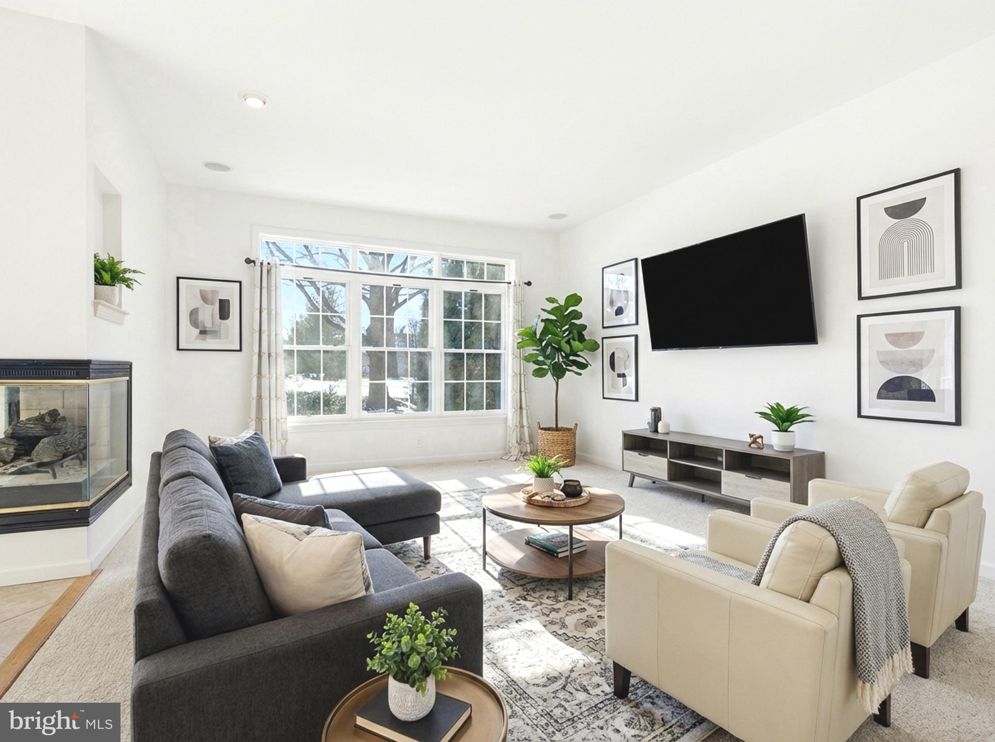 634 Northfield Road Lititz, PA 17543 - Photo 10 of 34 a living room with furniture a flat screen tv and a large window