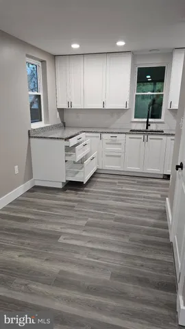 a kitchen with stainless steel appliances granite countertop a sink a stove and cabinets